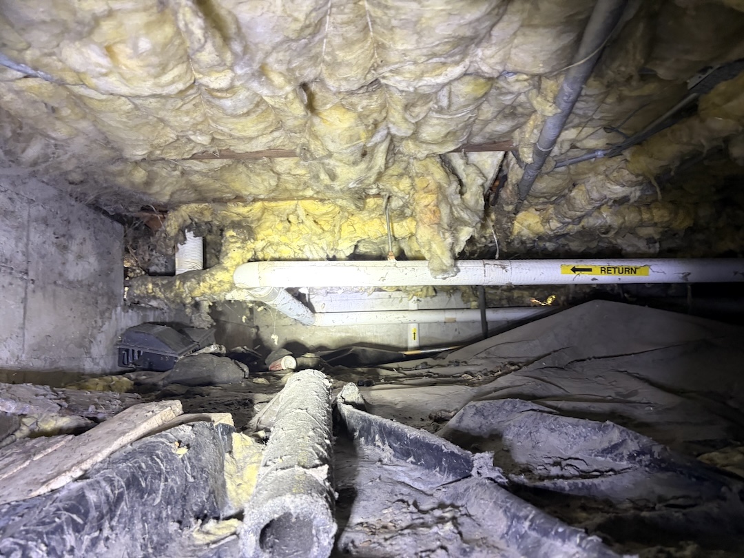 Before Crawl Space Restoration - Damaged Insulation And Vapor Barrier
